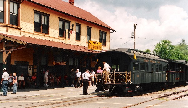 An open-platform observation car on the end of a train at Orbisonia