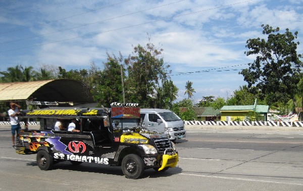 A jeepney honoring Saint Ignatius on the highway in El Salvador City