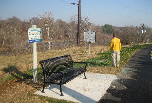 Bench, sign, and historical marker
